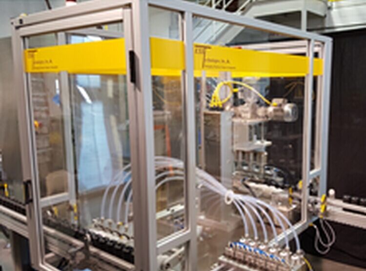 The Flexible Filler/Capper is designed to use a circular puck conveyor system to transport vials or small bottles to the inline filling system. © FANUC America
